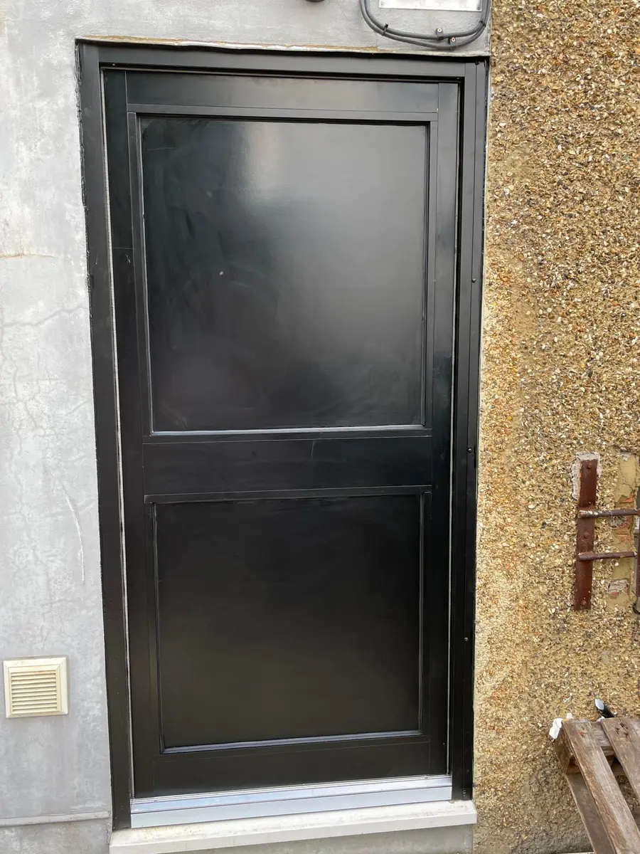 Solid black aluminium commercial single door fitted in London by Range Shop Fronts