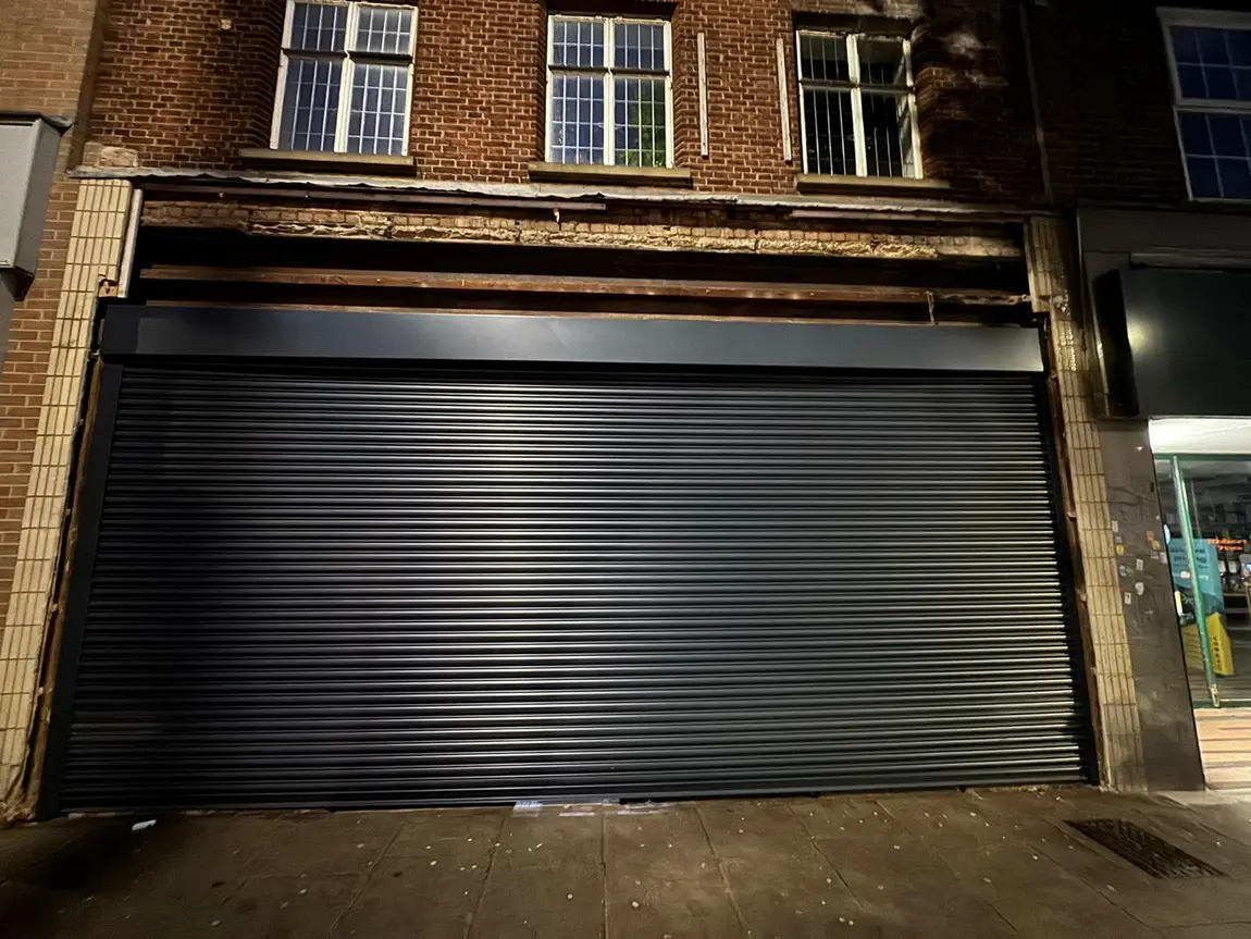 Black roller shutter protecting a London retail unit