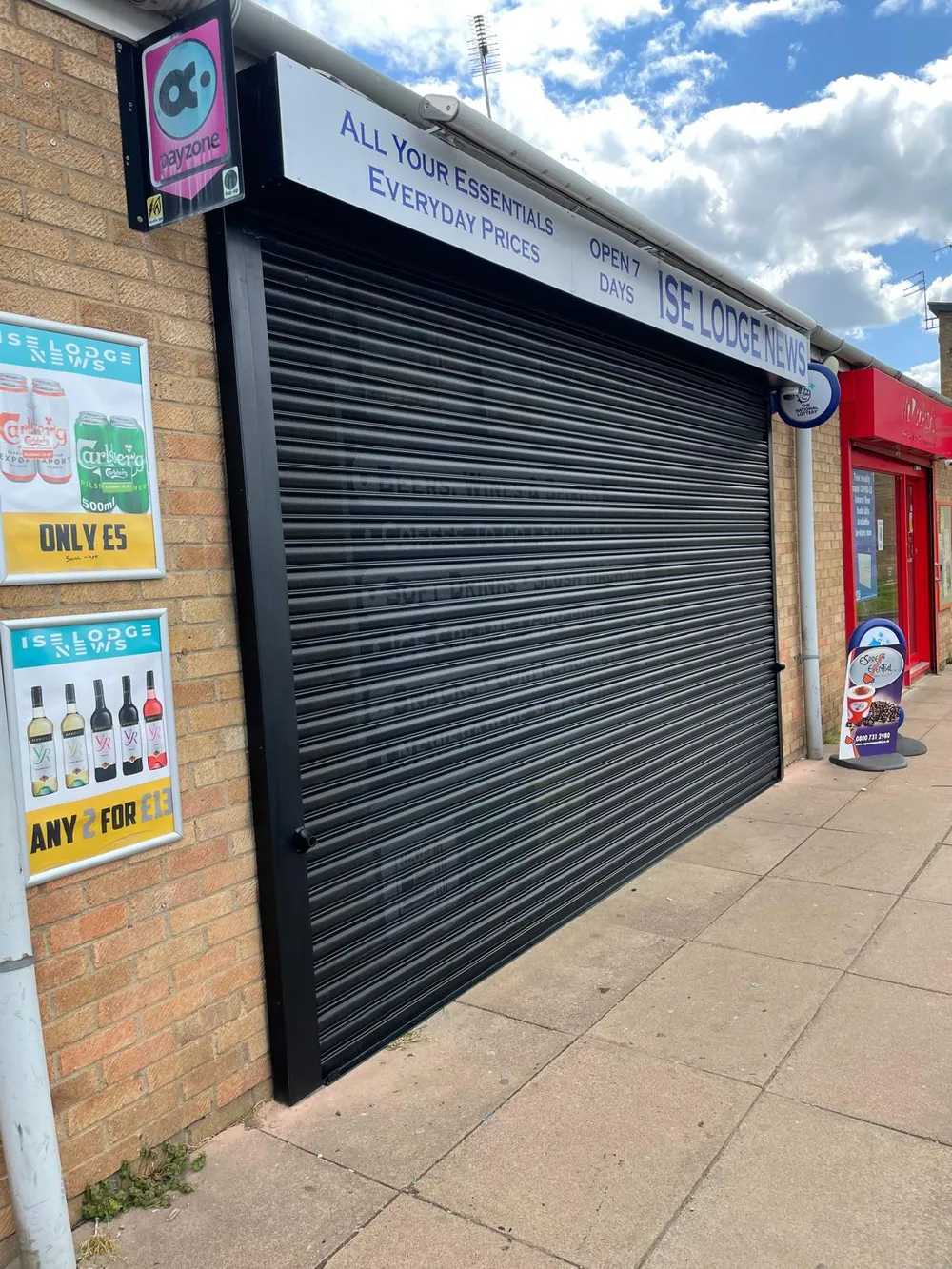 Black roller shutter secured over a London shopfront
