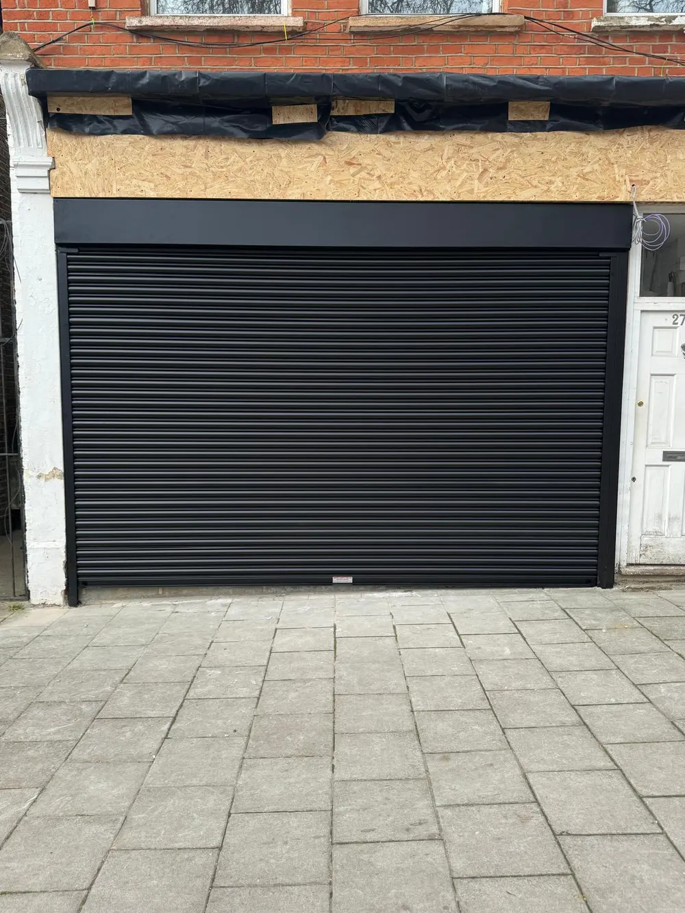 Anthracite roller garage door on a London home