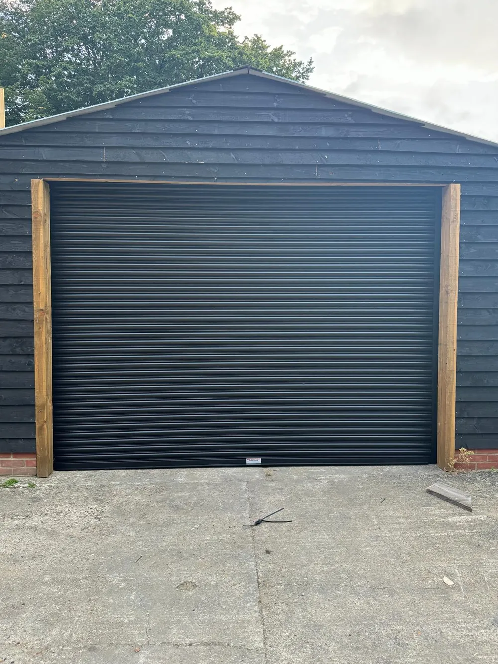 Anthracite insulated roller garage door installed on a London property