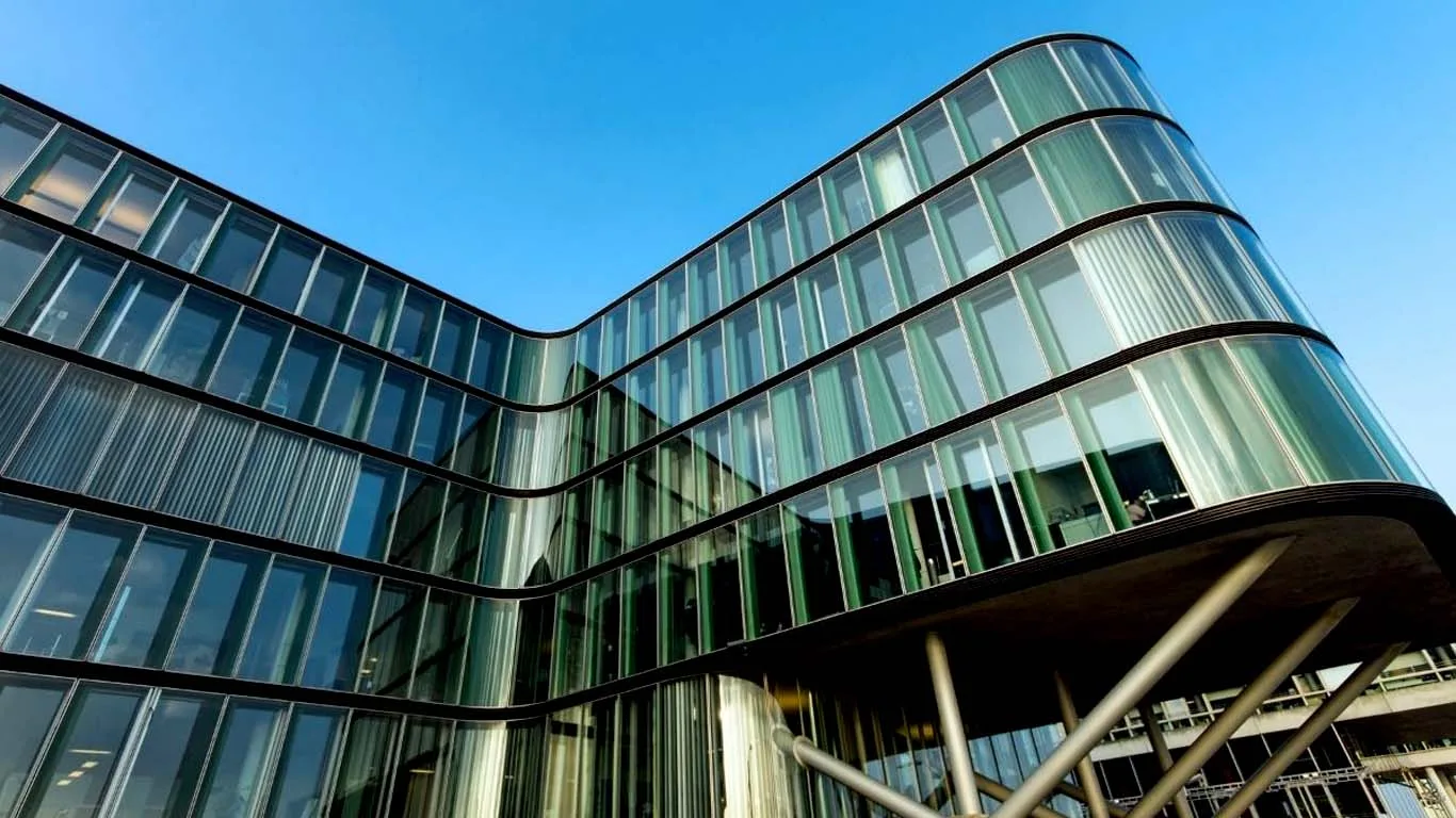 Curved glass curtain wall facade on a modern commercial building